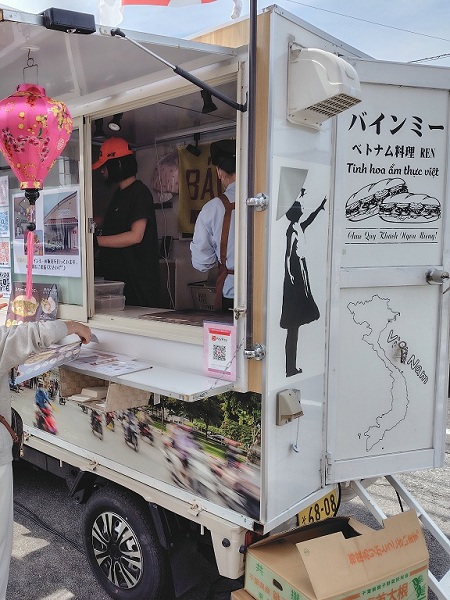 ベトナム料理店「REN」の、松本市出張販売の様子。白い看板のフードトラック。